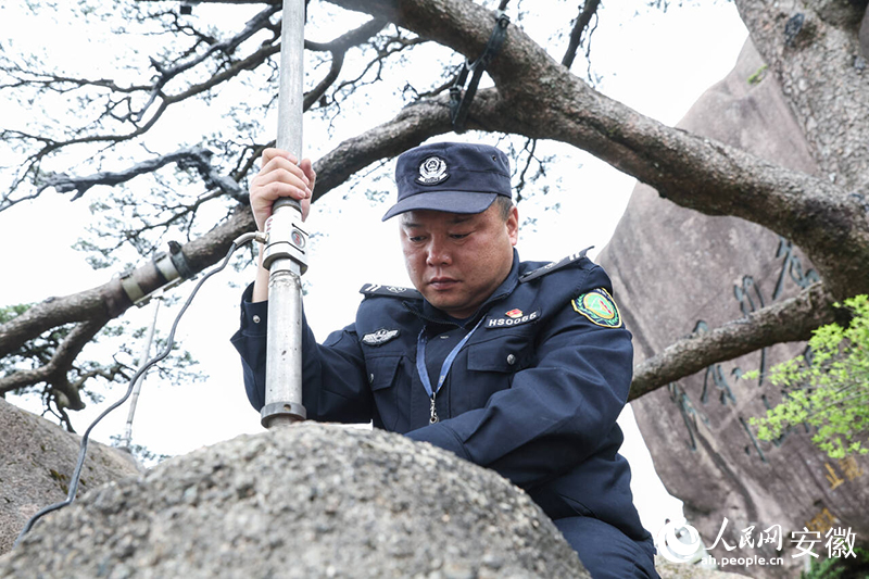 胡曉春檢查支撐桿松動情況。人民網(wǎng)記者 張俊攝